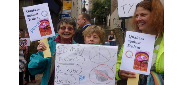 Three Friends holding placards.